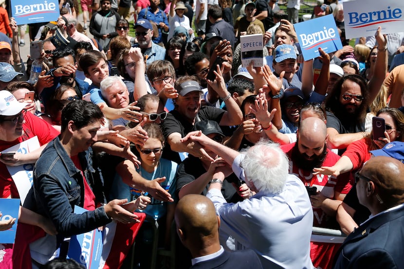 Democratic presidential candidate Sen. Bernie Sanders, I-Vt., shakes hands with people after...