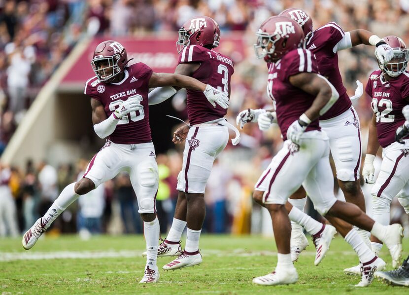 Texas A&M Aggies defensive back Demani Richardson (26) celebrates an interception with Texas...