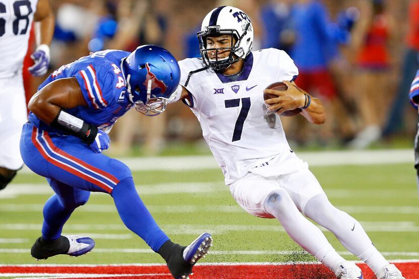 TCU Horned Frogs quarterback Kenny Hill (7) tries to cut back across the midfield after...