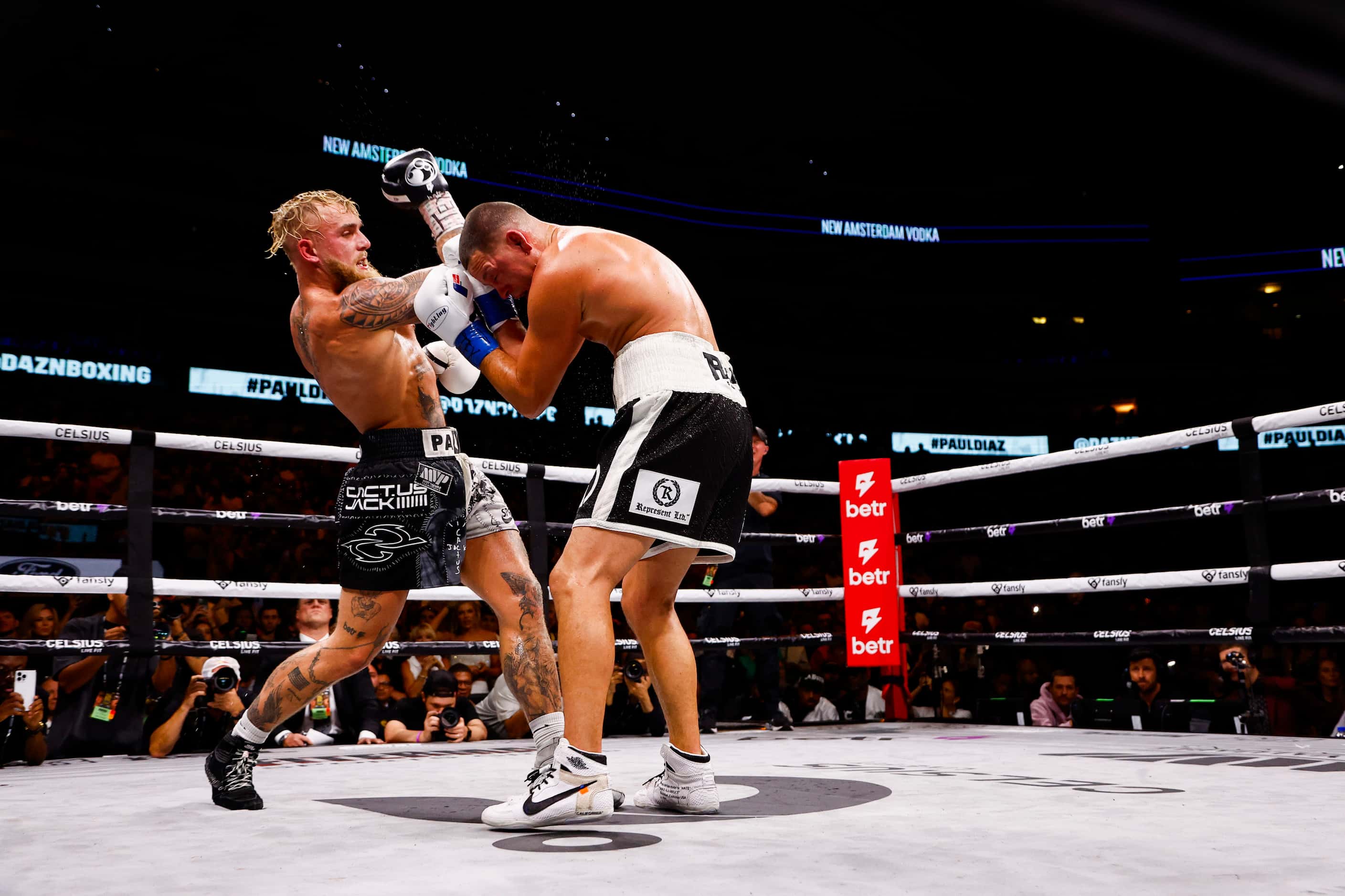 Jake Paul, left, throws an uppercut on Nate Diaz during a boxing match in Dallas, Saturday,...