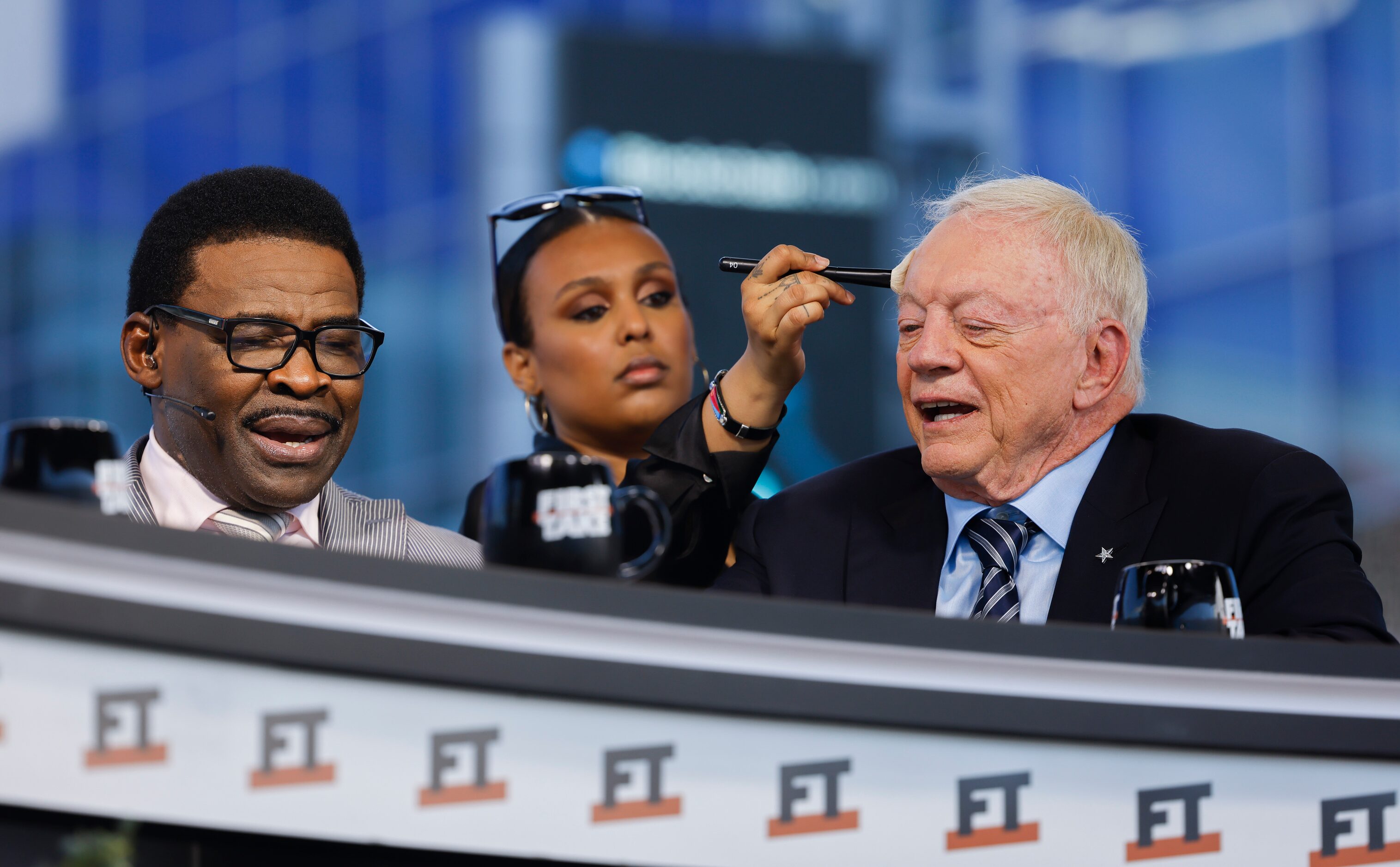 A crew member grooms former Dallas Cowboys owner Jerry Jones, right, as former Cowboys...