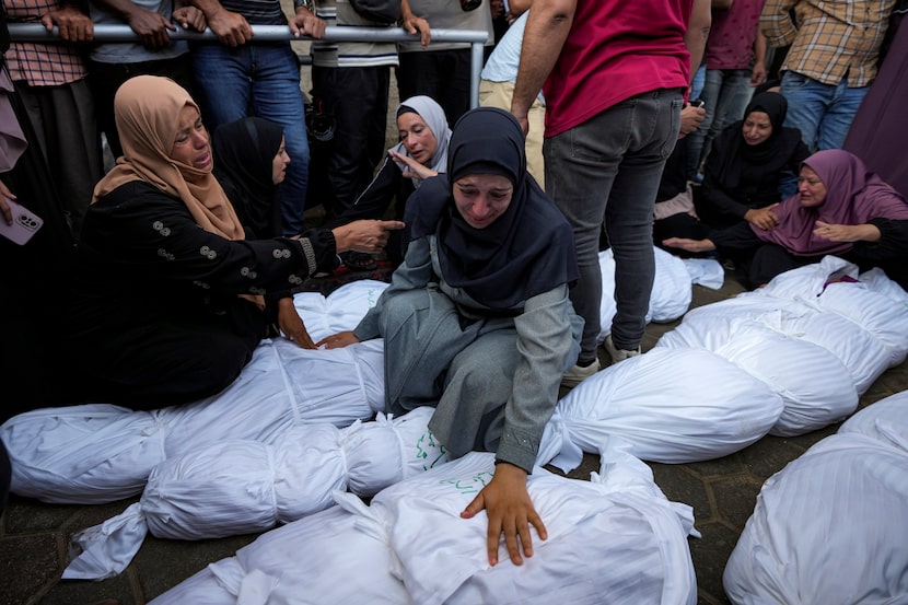 Palestinians mourn relatives killed in the Israeli bombardment of the Gaza Strip, at a...