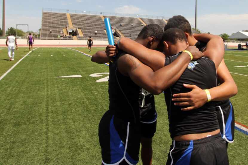 Members of the North Forney Boys relay team pause and pray before their first event of the...