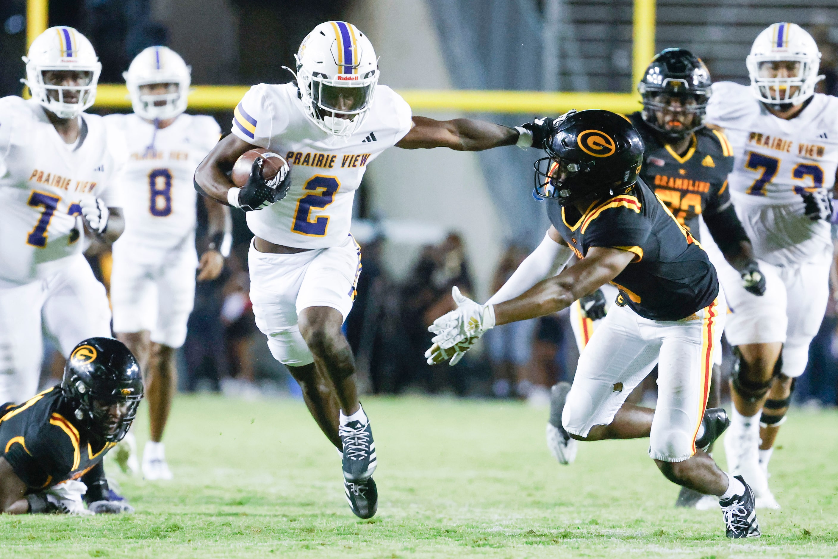 Prairie View A&M running back Connor Wisham (2) applies a stiff-arm on Grambling State Caleb...