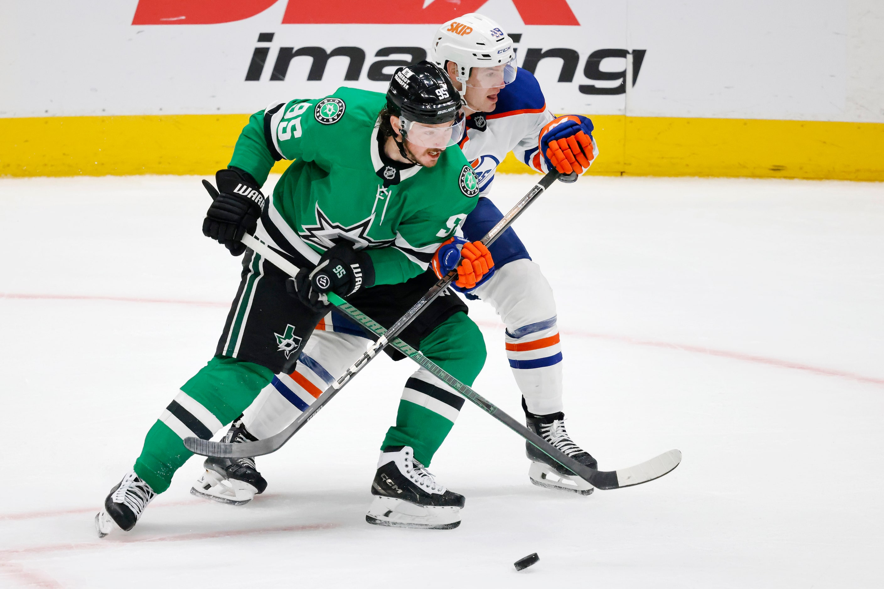 Dallas Stars center Matt Duchene (95) keeps the puck from Edmonton Oilers defenseman Ty...