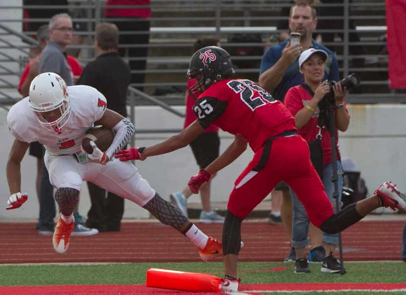 Aledo's Jeffery Carter (3) maintains possession of the ball despite taking a hit from...