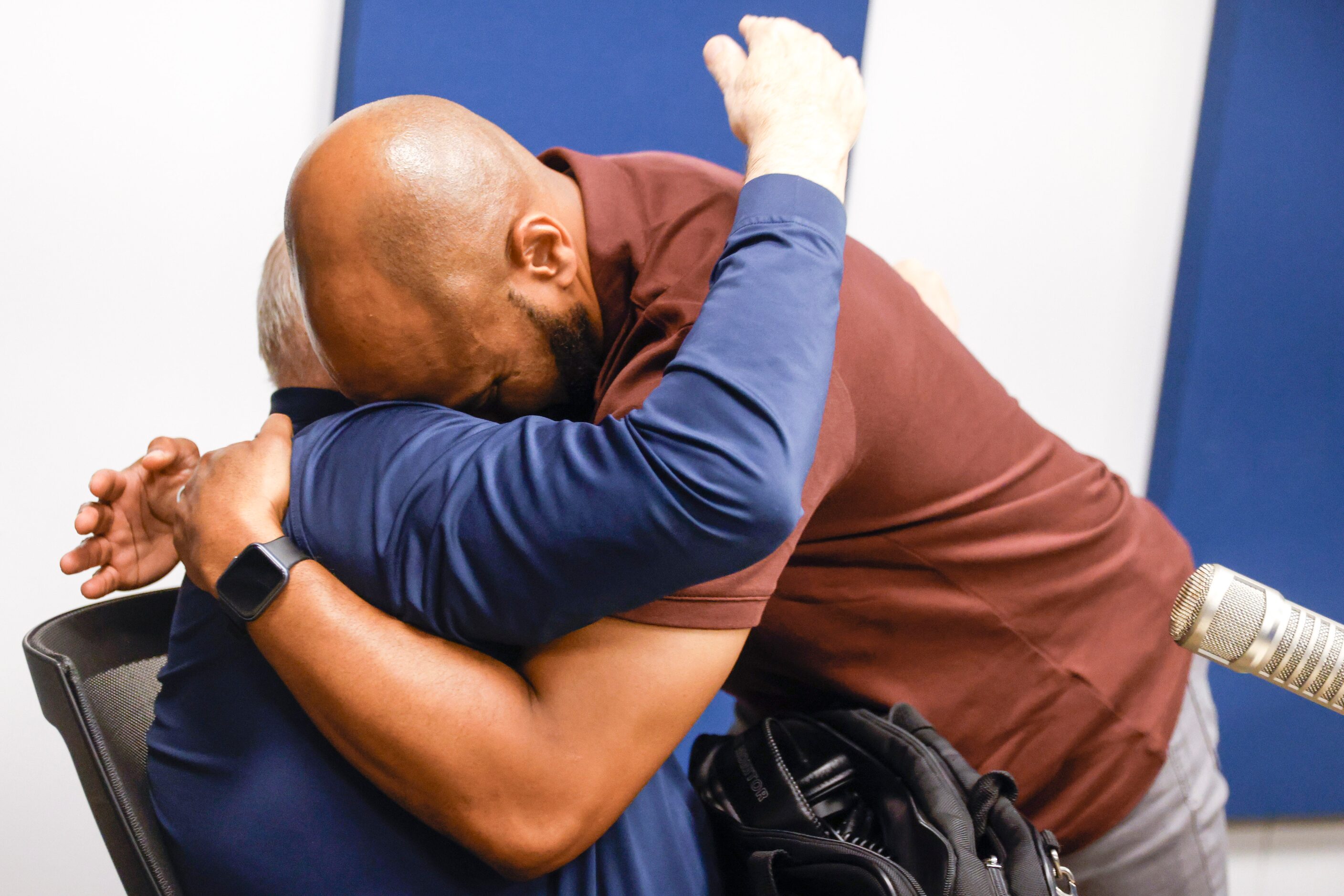 Local sports radio legend Norm Hitzges (left) embraces his co-host Donovan Lewis after his...