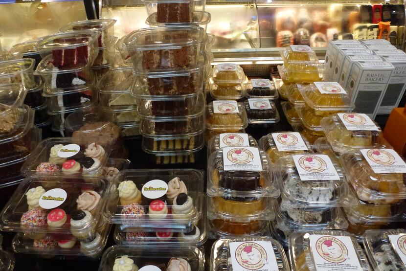 Check out the top of the Royal Blue Grocery cheese counter, where many individual cakes are...