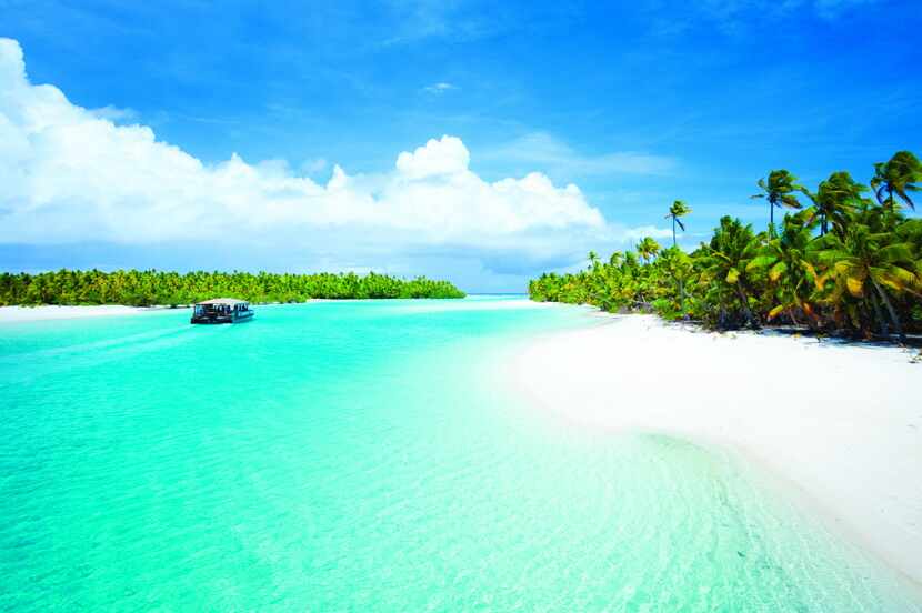 The catamaran Titiaitonga motors past One Foot Island as it takes visitors to Aitutaki on a...