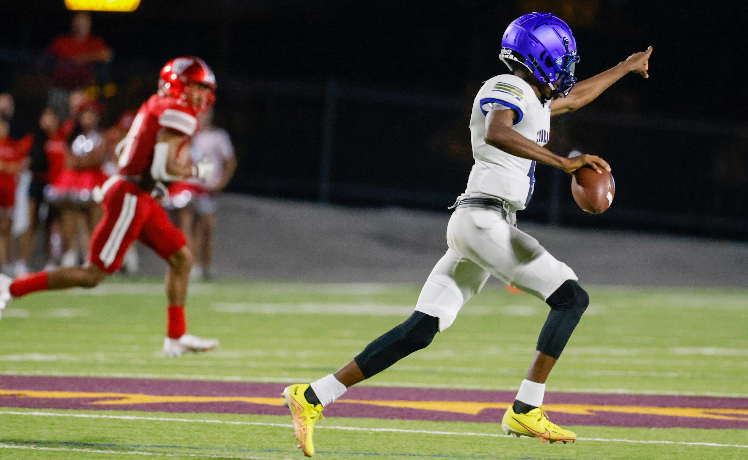 Conrad quarterback Ladavian Frost-Harris (8) points downfield as he runs with the ball...