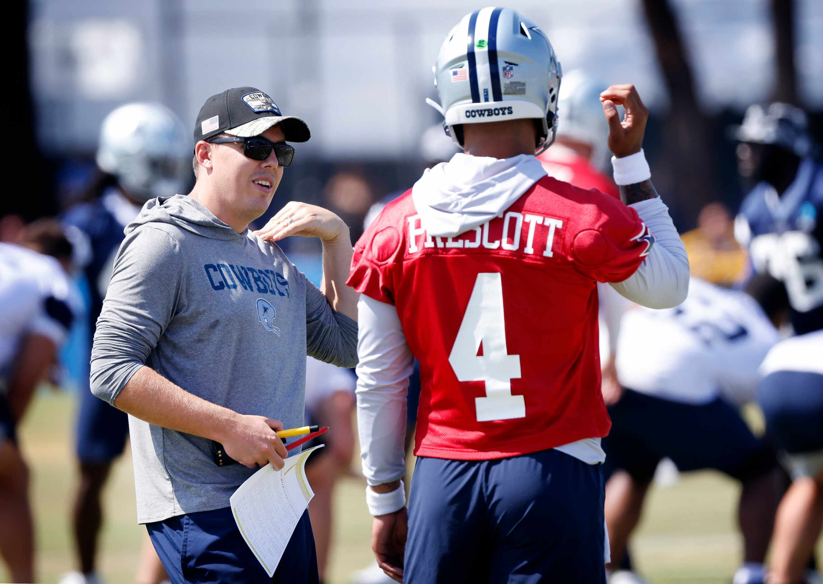 Dallas Cowboys quarterback Dak Prescott (4) and offensive coordinator Kellen Moore compares...
