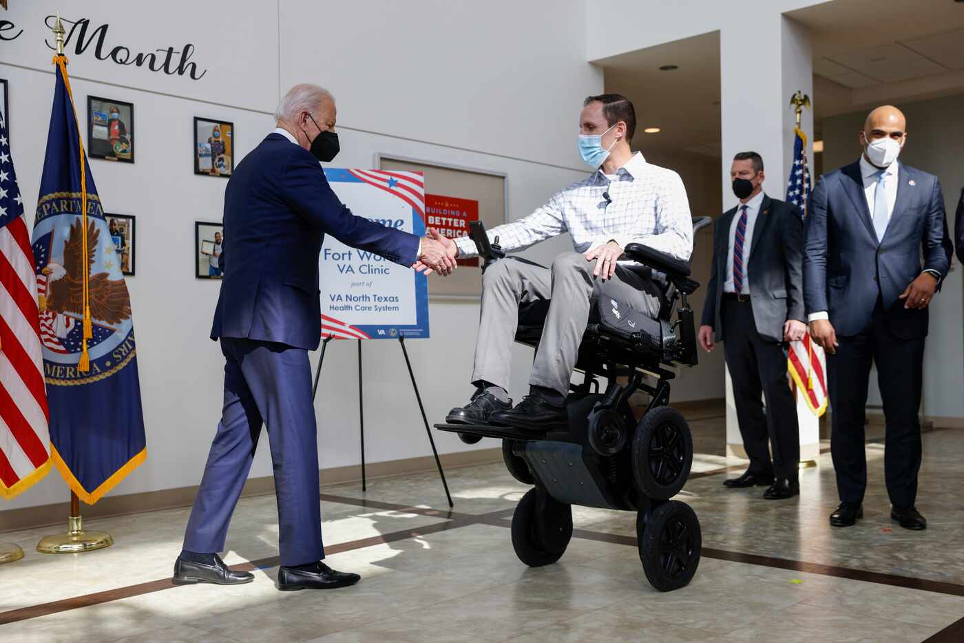 President Joe Biden greets lead physical therapist Josh Geering after demonstrating the...