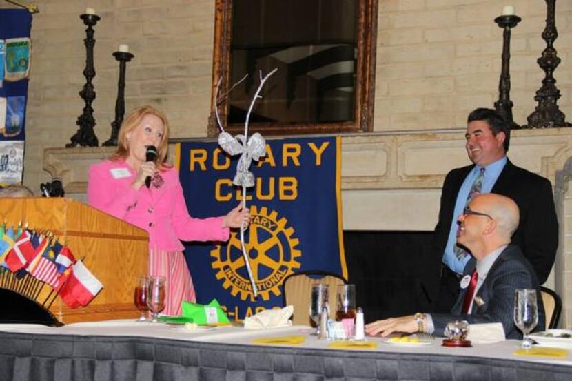 Kass Prince, left, presents a joke parting gift to Irving Chamber President Chris Wallace at...