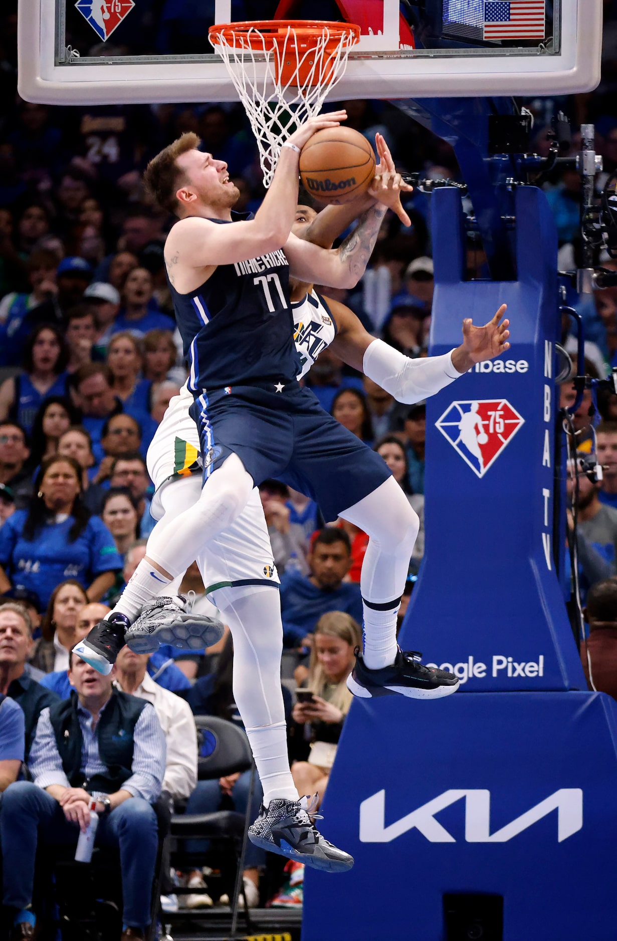 Dallas Mavericks guard Luka Doncic (77) is fouled by Utah Jazz center Hassan Whiteside (21)...