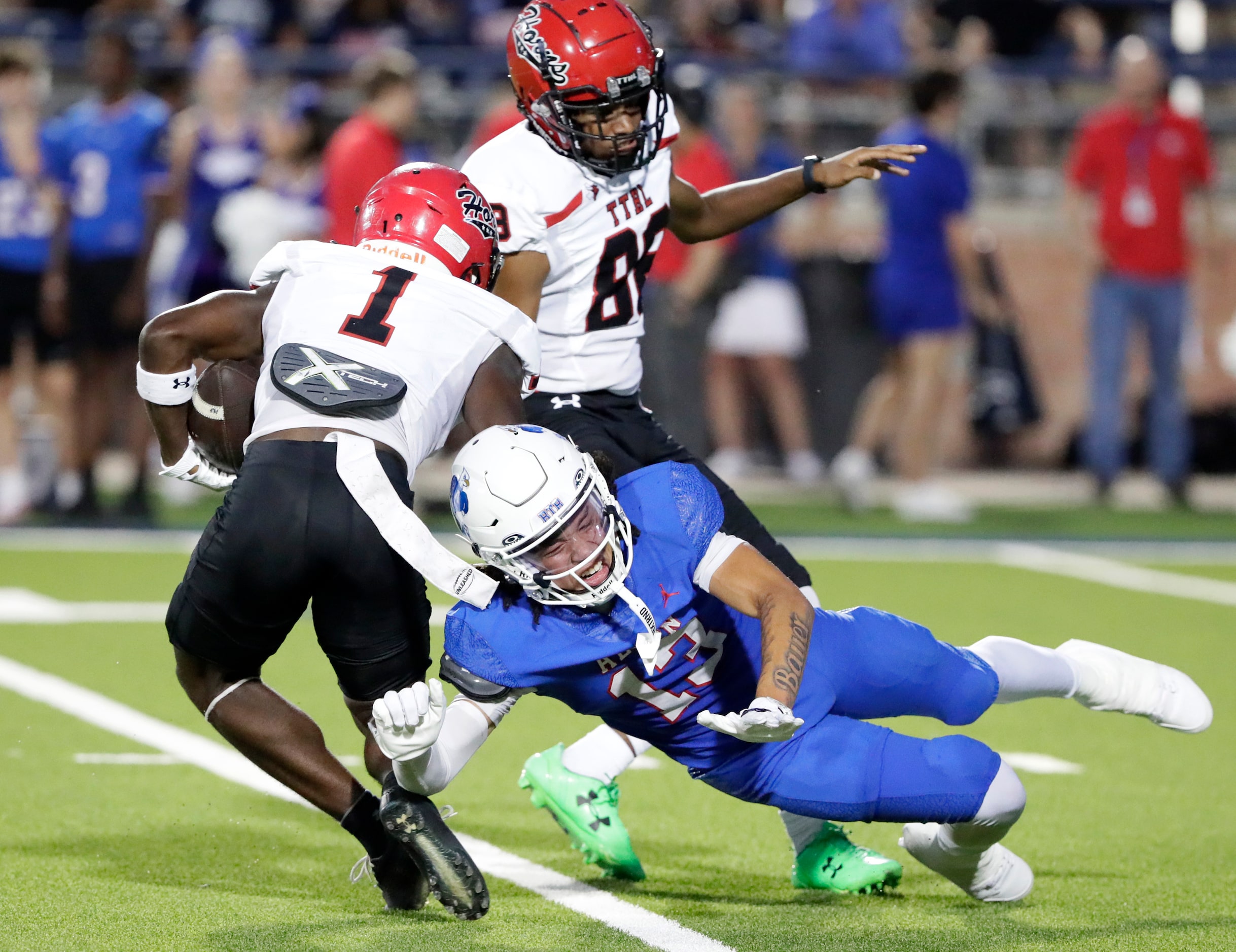 Allen High School defensive back LeBron Bauer (13) breaks up an extra point kick attempt...