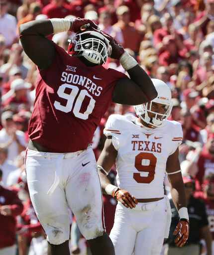 Oklahoma Sooners defensive lineman Neville Gallimore (90) reacts after a tackle is made in...
