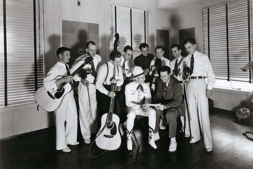 Gene Autry (seated on left) visits with western swing band the Light Crust Doughboys at the...