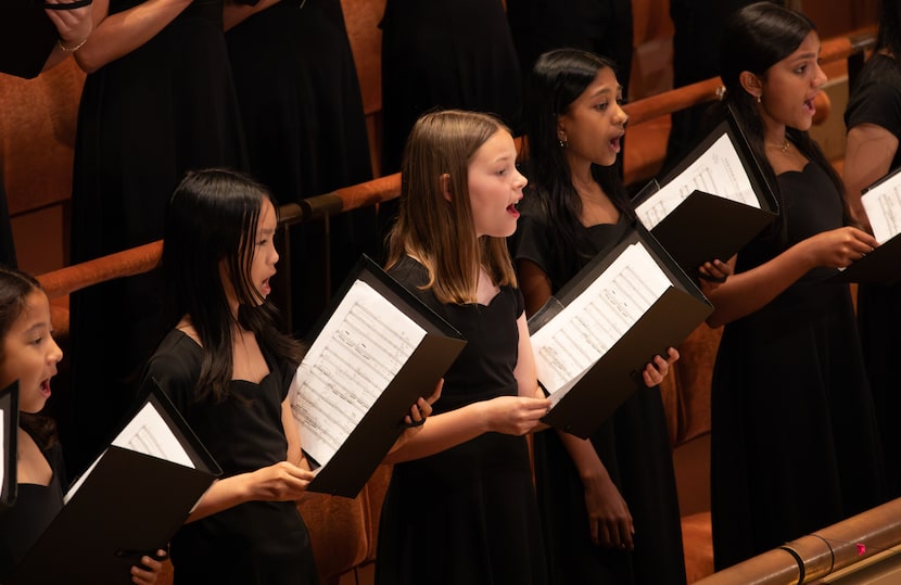 Members of the Dallas Symphony Children's Chorus perform with the DSO and guest conductor...