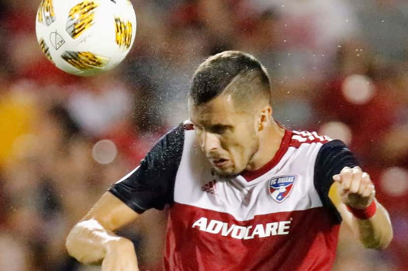 FC Dallas defender Matt Hedges (24) heads the soccer ball during the second half as FC...