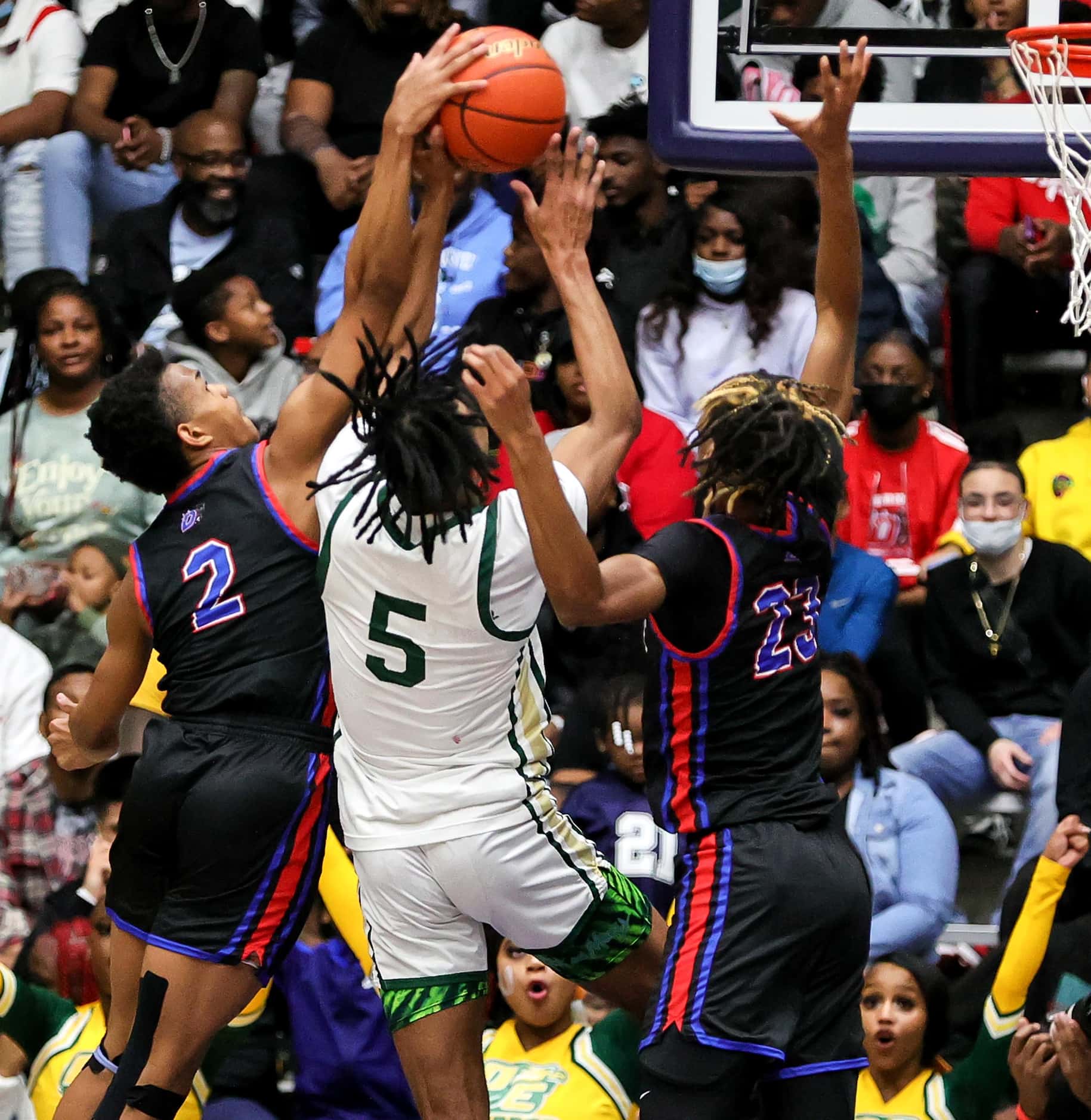 DeSoto forward Ahmir Wall (5) goes strong to the basket against Duncanville Evan Phelps (2)...