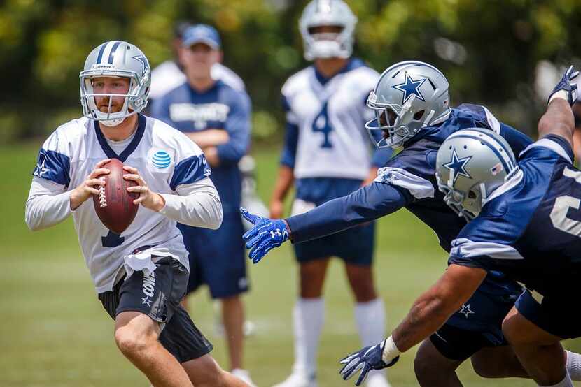 Dallas Cowboys quarterback Cooper Rush (7) avoids the rush during the team's minicamp at The...