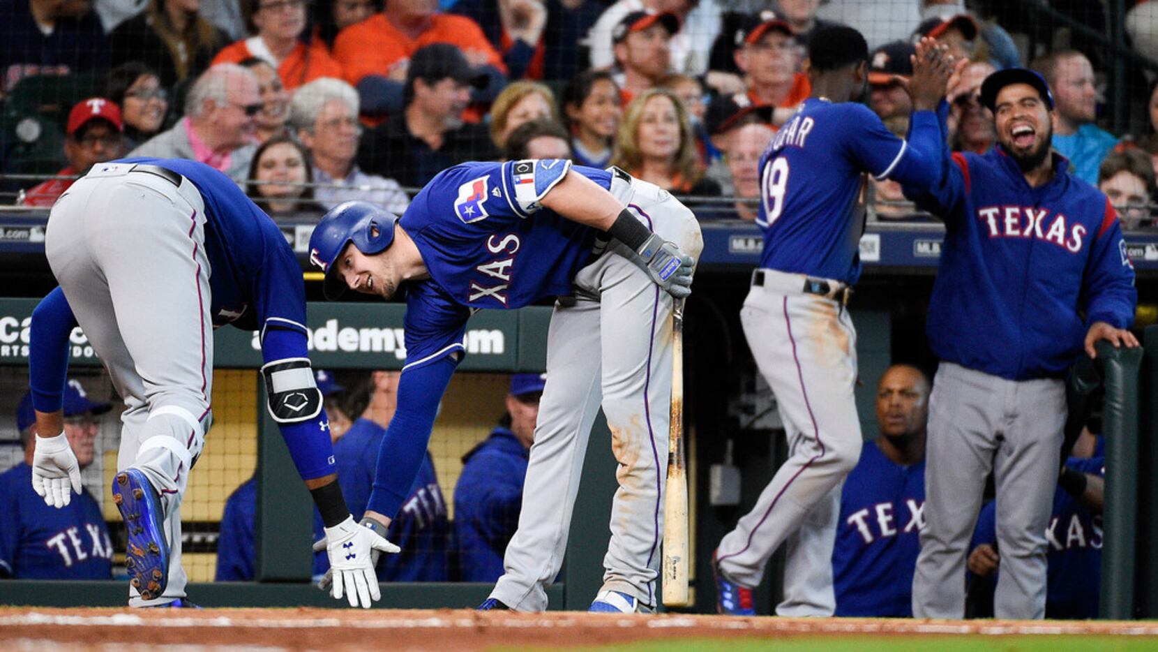 Texas Rangers' Ronald Guzman, left, celebrates his game-tying home run off Houston Astros...