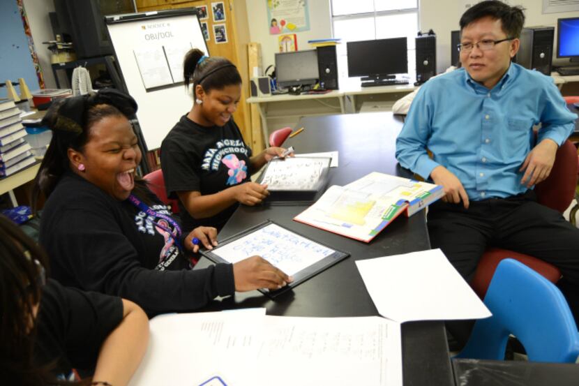 Kastasha Bates (far left) laughs during a math lesson at Maya Angelou High School with...