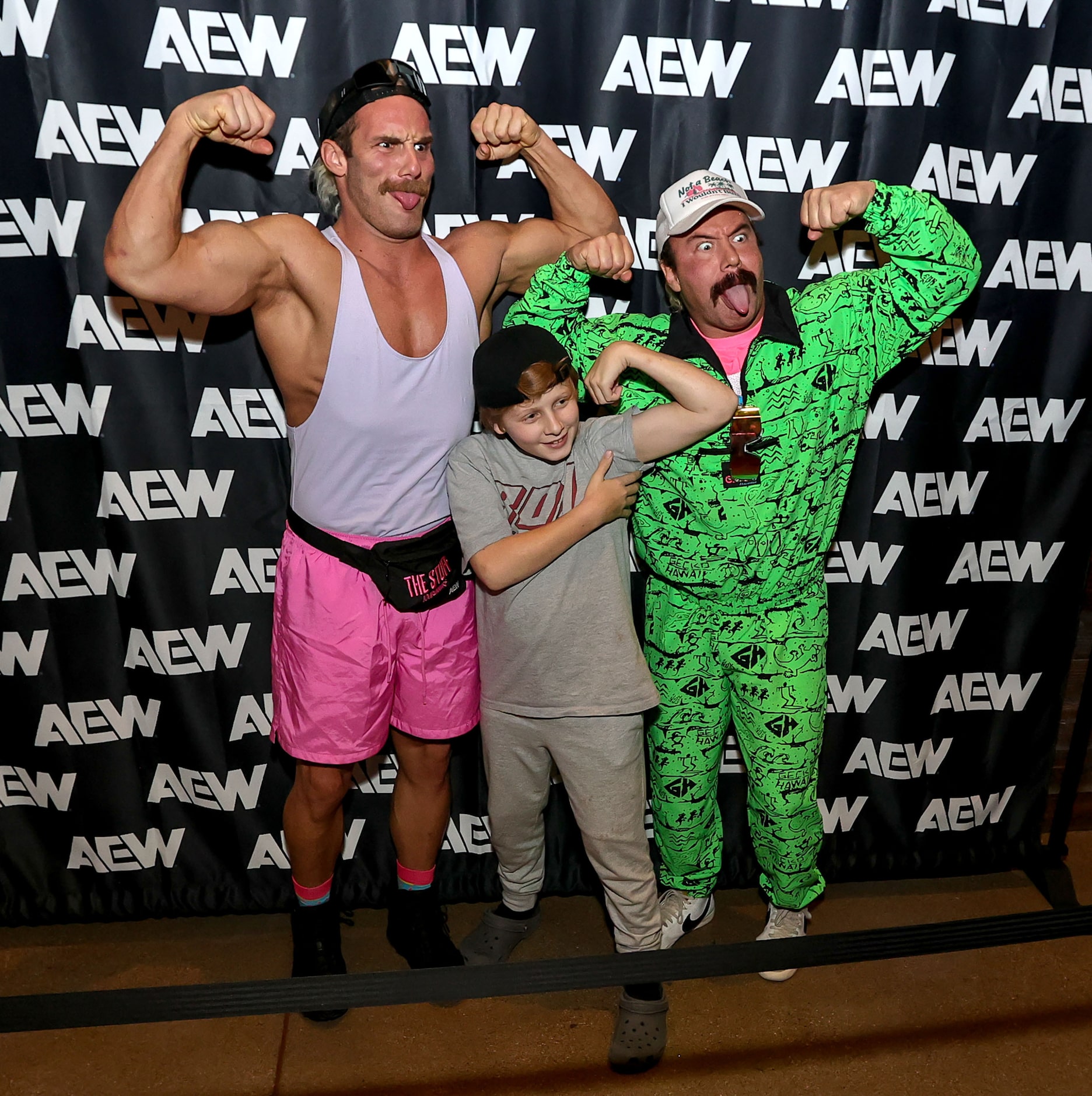 The Outrunners  take a photo with a young fan at the All Elite Wrestling kickoff party on...