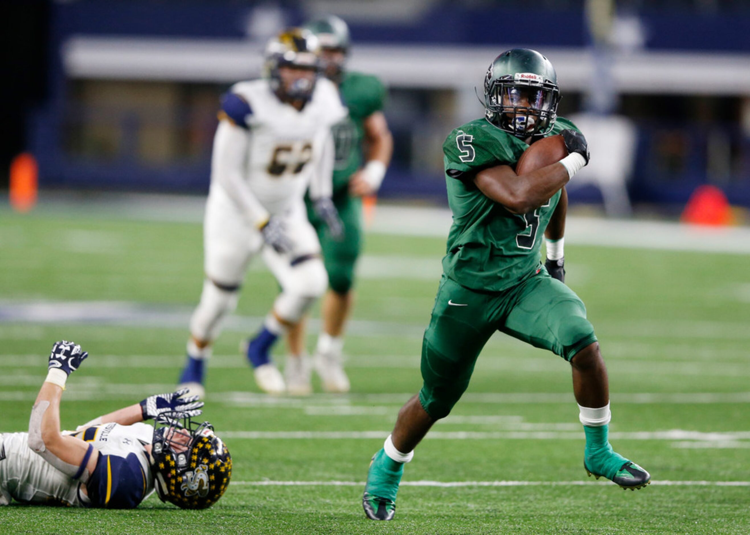 Kennedale's Jaden Knowles (5) breaks away from Stephenville's Gage Graham (25) on his way to...