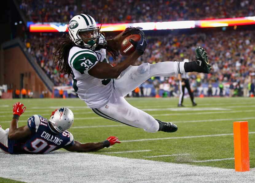 FOXBORO, MA - OCTOBER 16:  Chris Ivory #33 of the New York Jets is knocked out of bounds...
