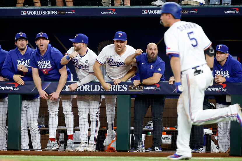 Texas Rangers players react to Corey Seager’s game-tying ninth inning homer in Game 1 of the...