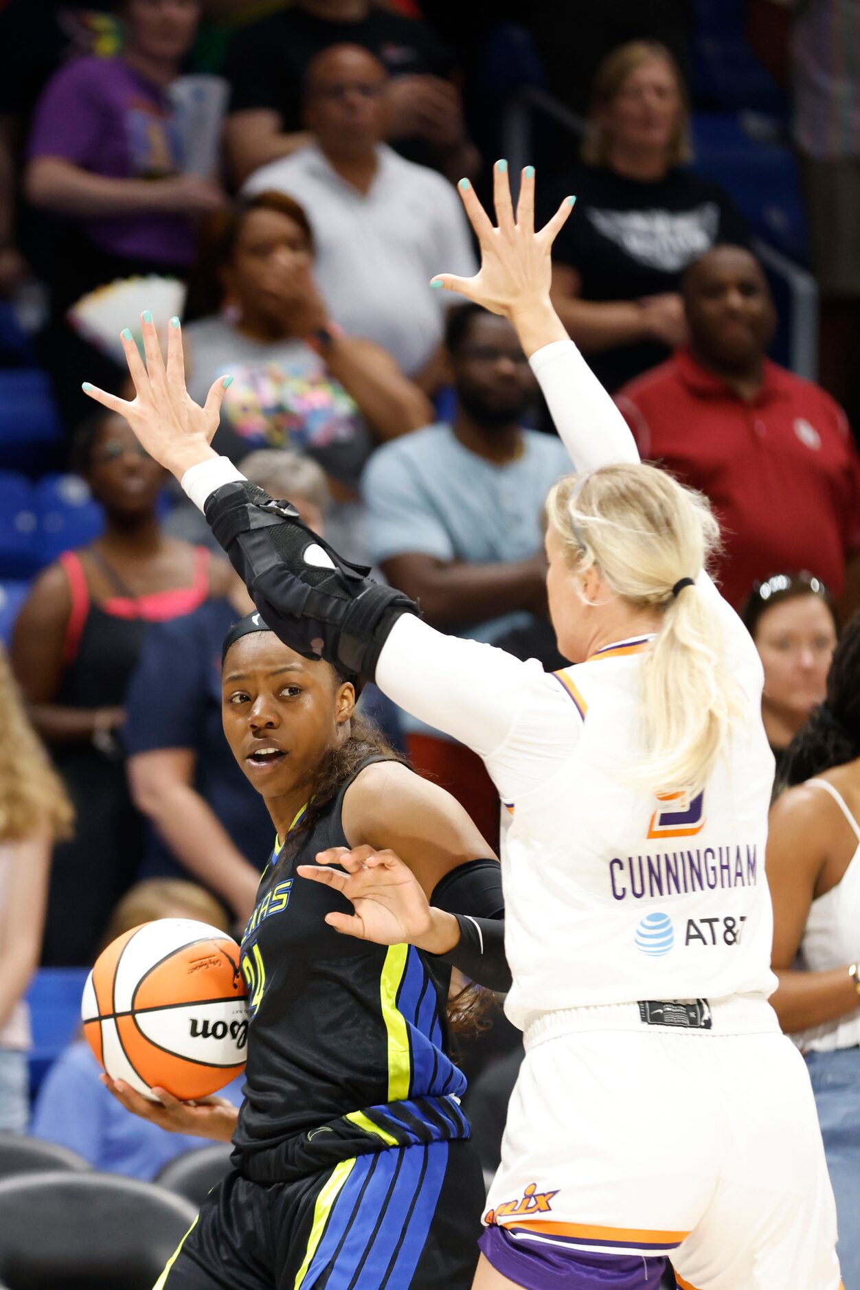 Dallas Wings guard Arike Ogunbowale (24) tries to get the ball past Phoenix Mercury guard...