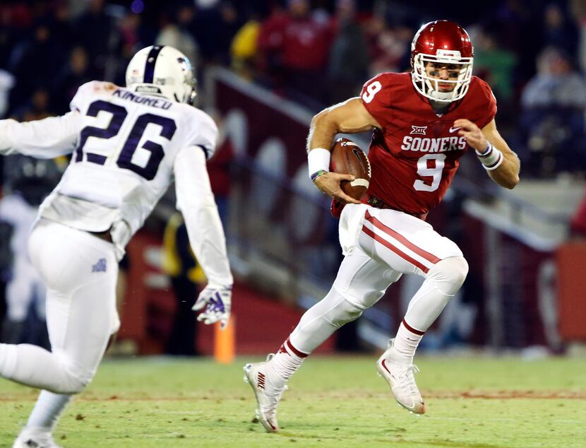 FILE - In this Nov. 21, 2015, file photo, Oklahoma quarterback Trevor Knight (9) runs as TCU...