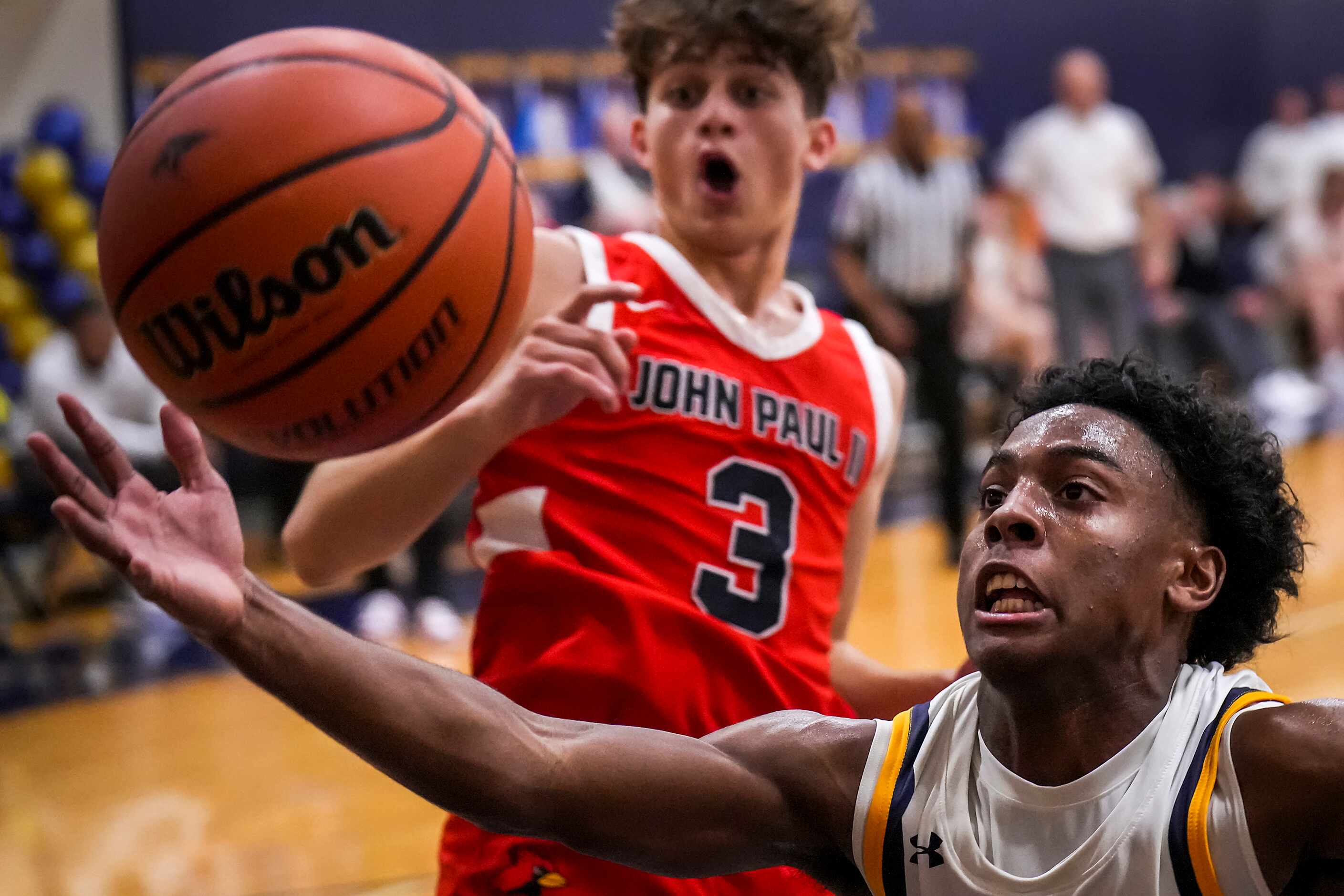 Prestonwood Christian's Nathan Stafford reaches for a rebound against John Paul II's Ofri...