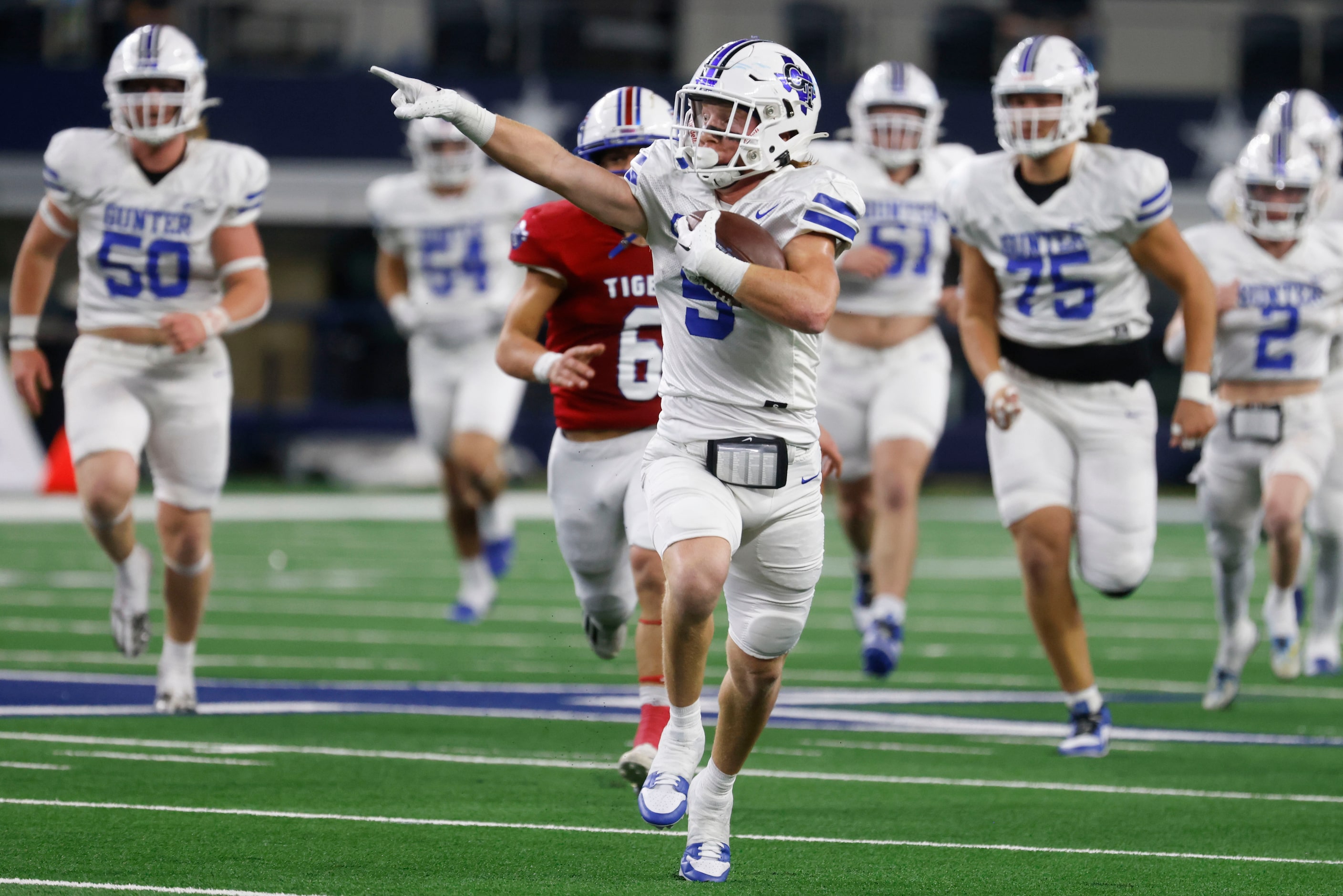 Gunter High’s Cannon Lemberg (5) points towards the sideline as he runs for a touchdown...