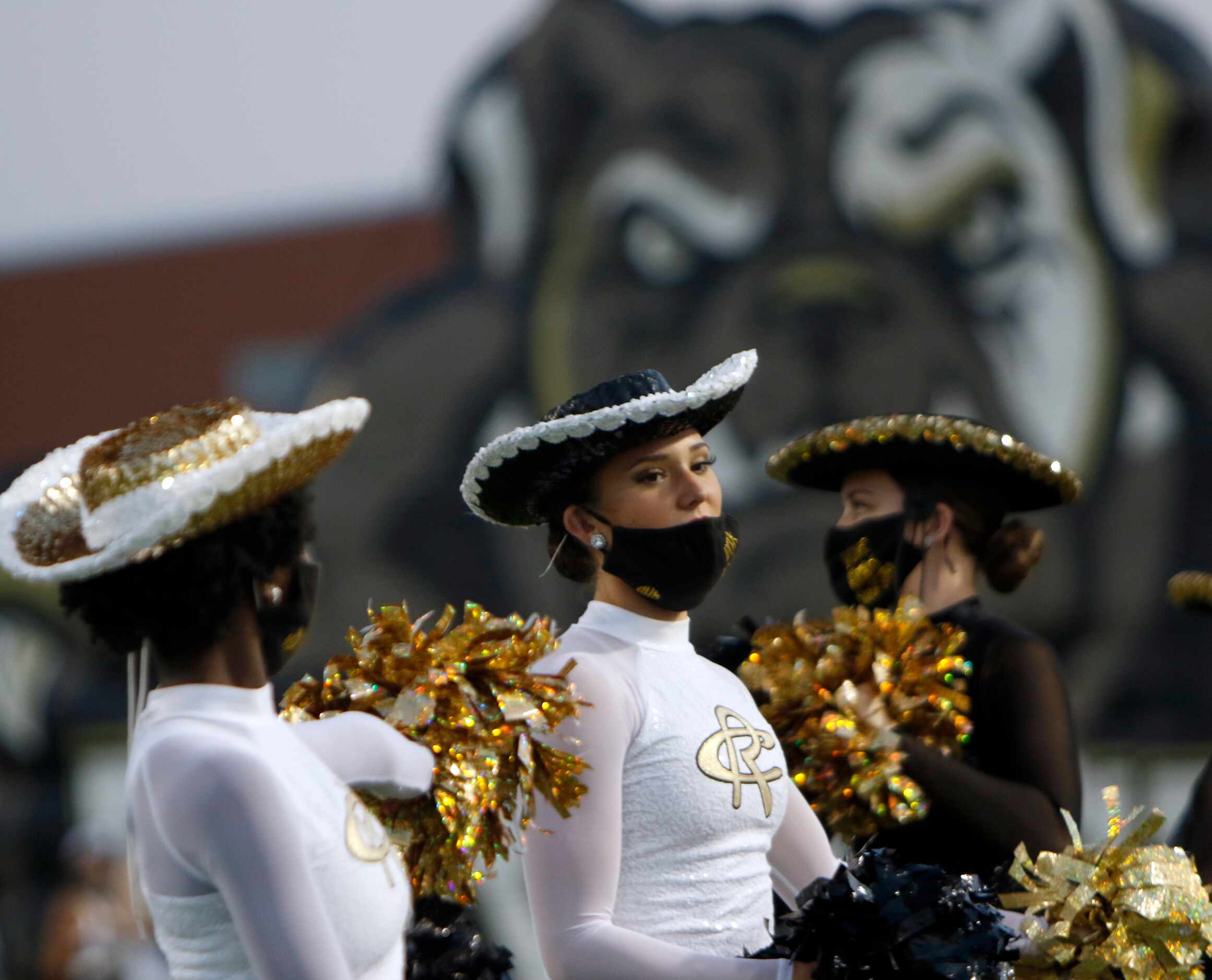 Royse City drill team members await the arrival of bulldogs players onto the field from the...