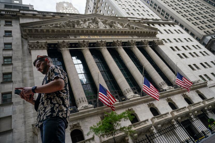 FILE - Pedestrians walk past the New York Stock Exchange, July 8, 2022, in New York. Stocks...