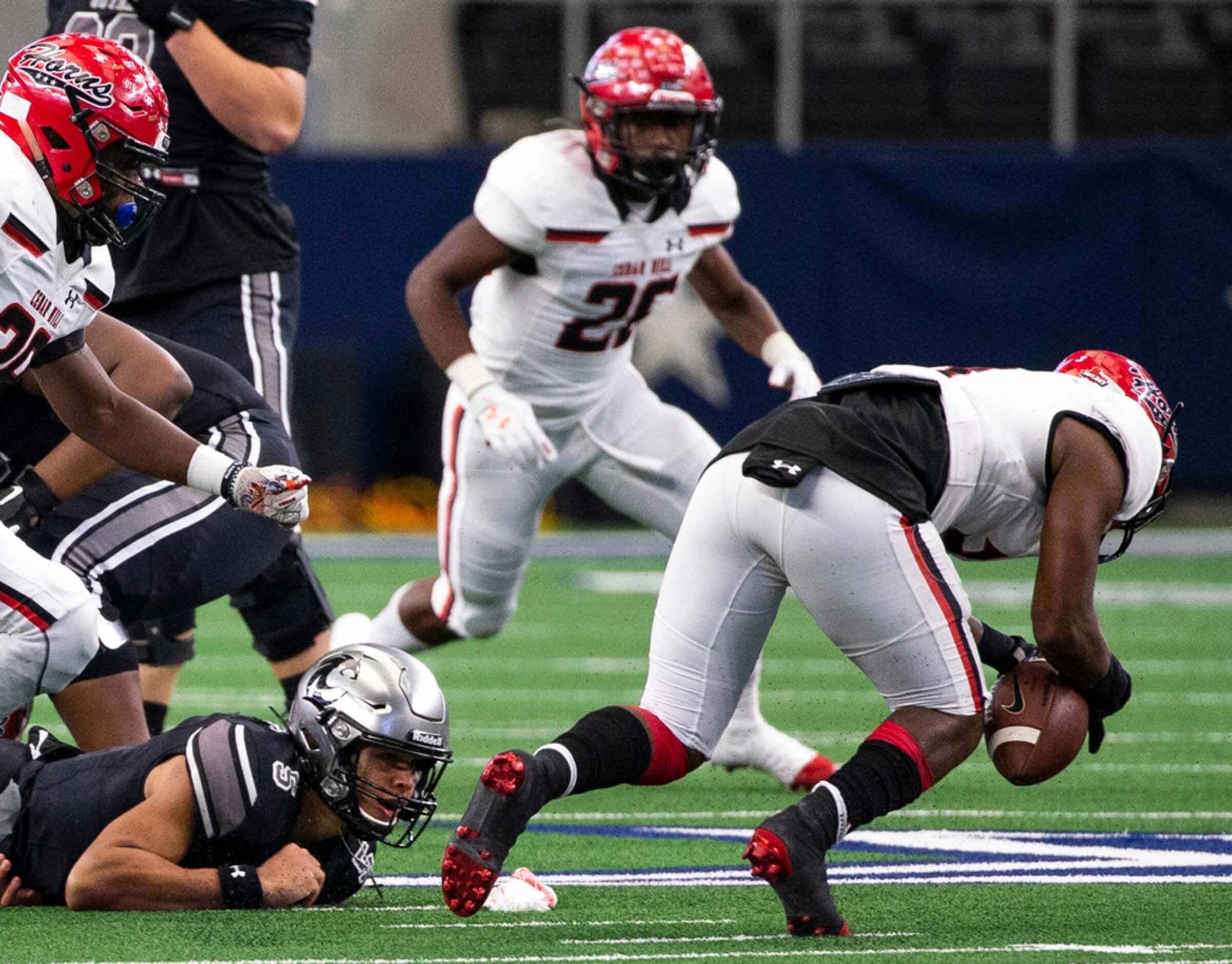 Denton Guyer quarterback Eli Stowers (5) watches as Cedar Hill free safety Dedryc Hutchings...