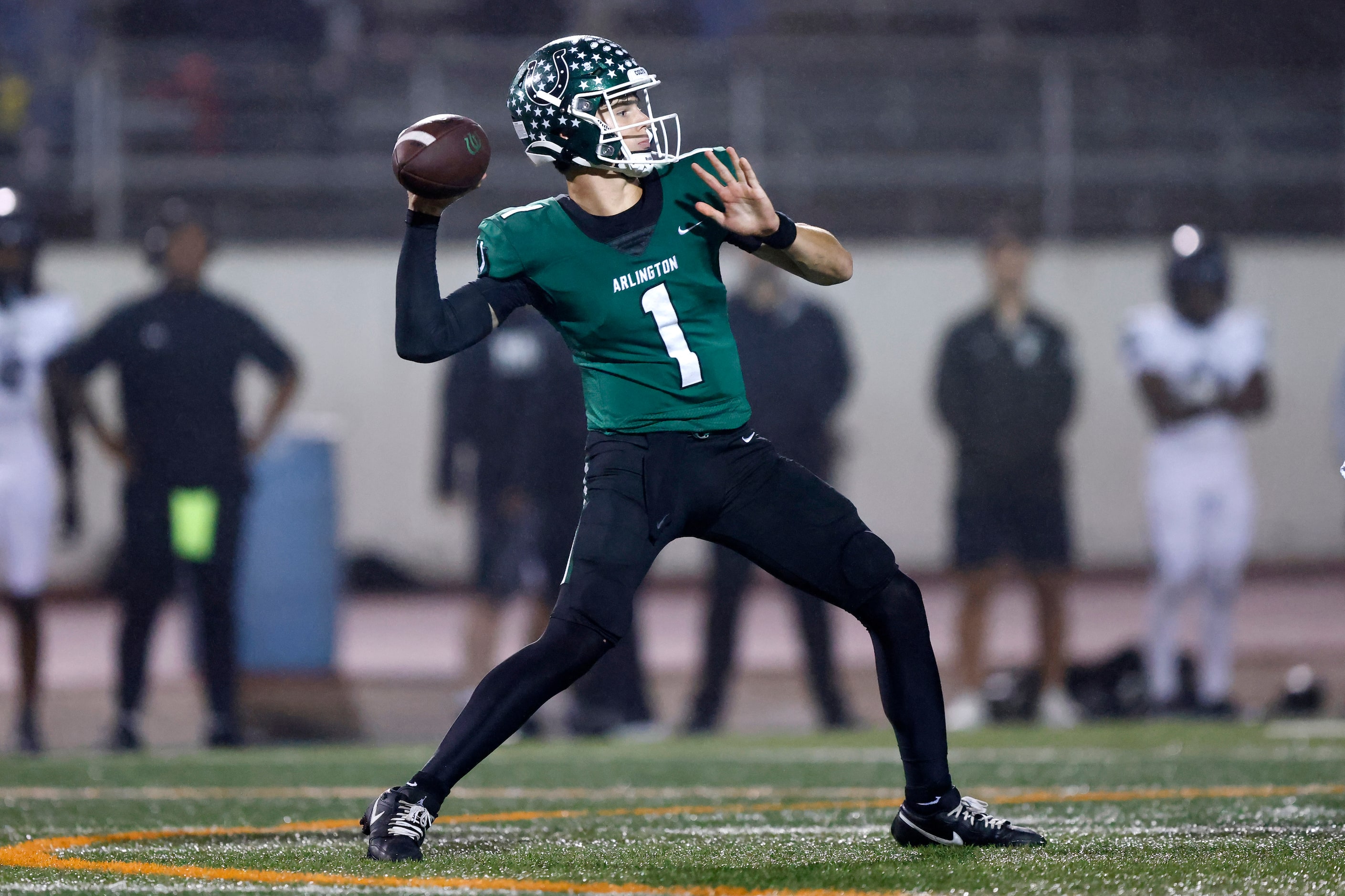 Arlington High quarterback Coleman Cravens (1) throws a third quarter touchdown pass to...