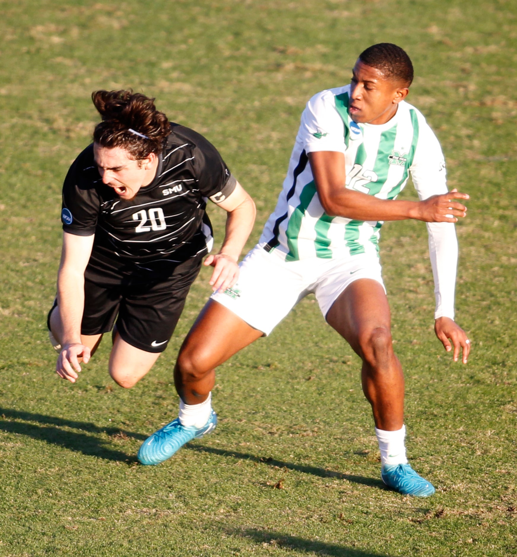 SMU Mustangs midfielder Nikola Djordjevic (20), left, skies after colliding with Marshall...