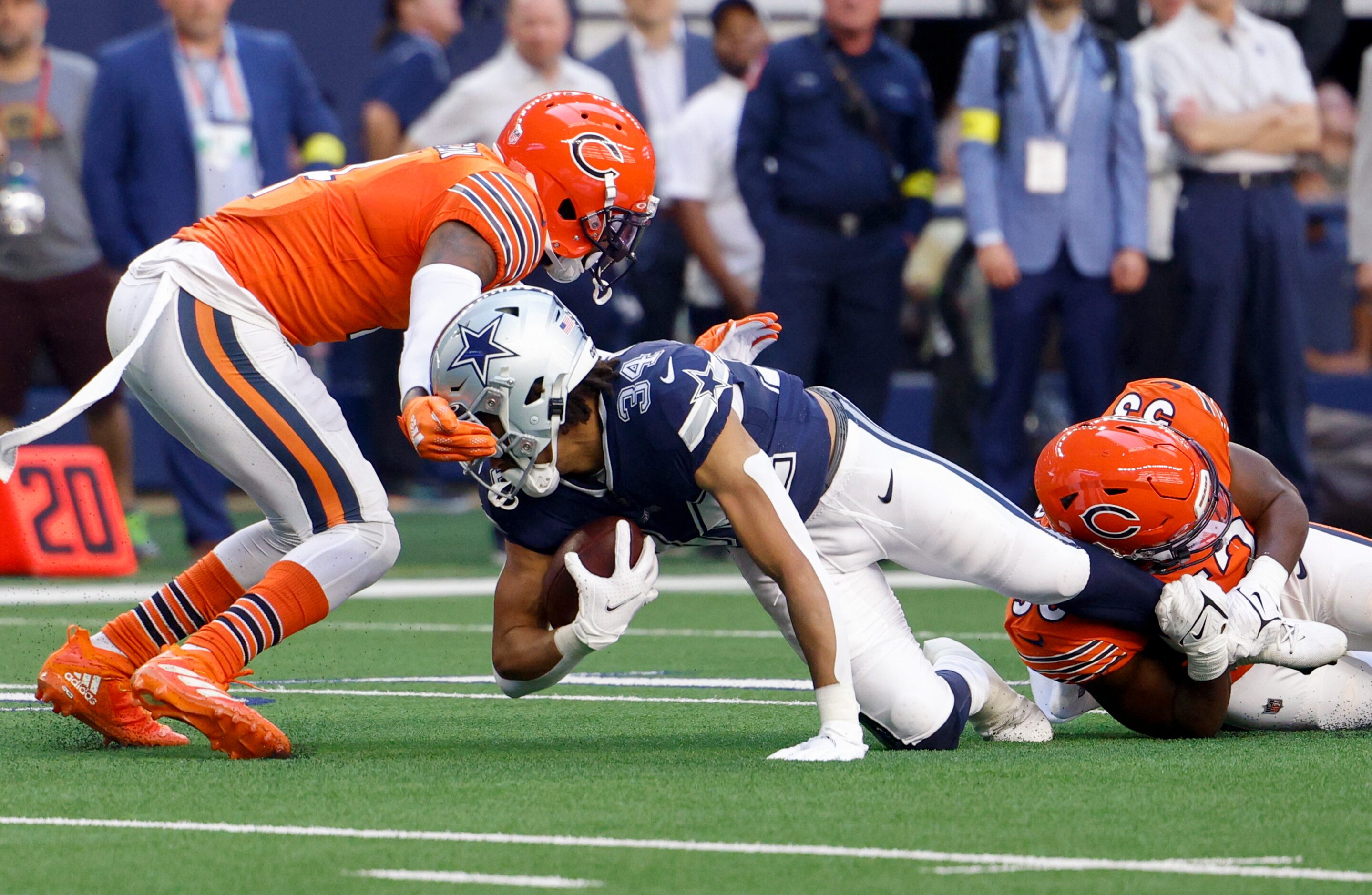 Chicago Bears safety Eddie Jackson (4) grabs the helmet of Dallas Cowboys running back Malik...