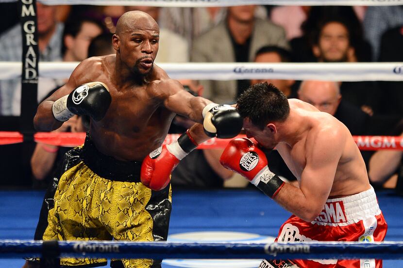 LAS VEGAS, NV - MAY 04:  (L-R) Floyd Mayweather Jr. throws a left to the face of Robert...