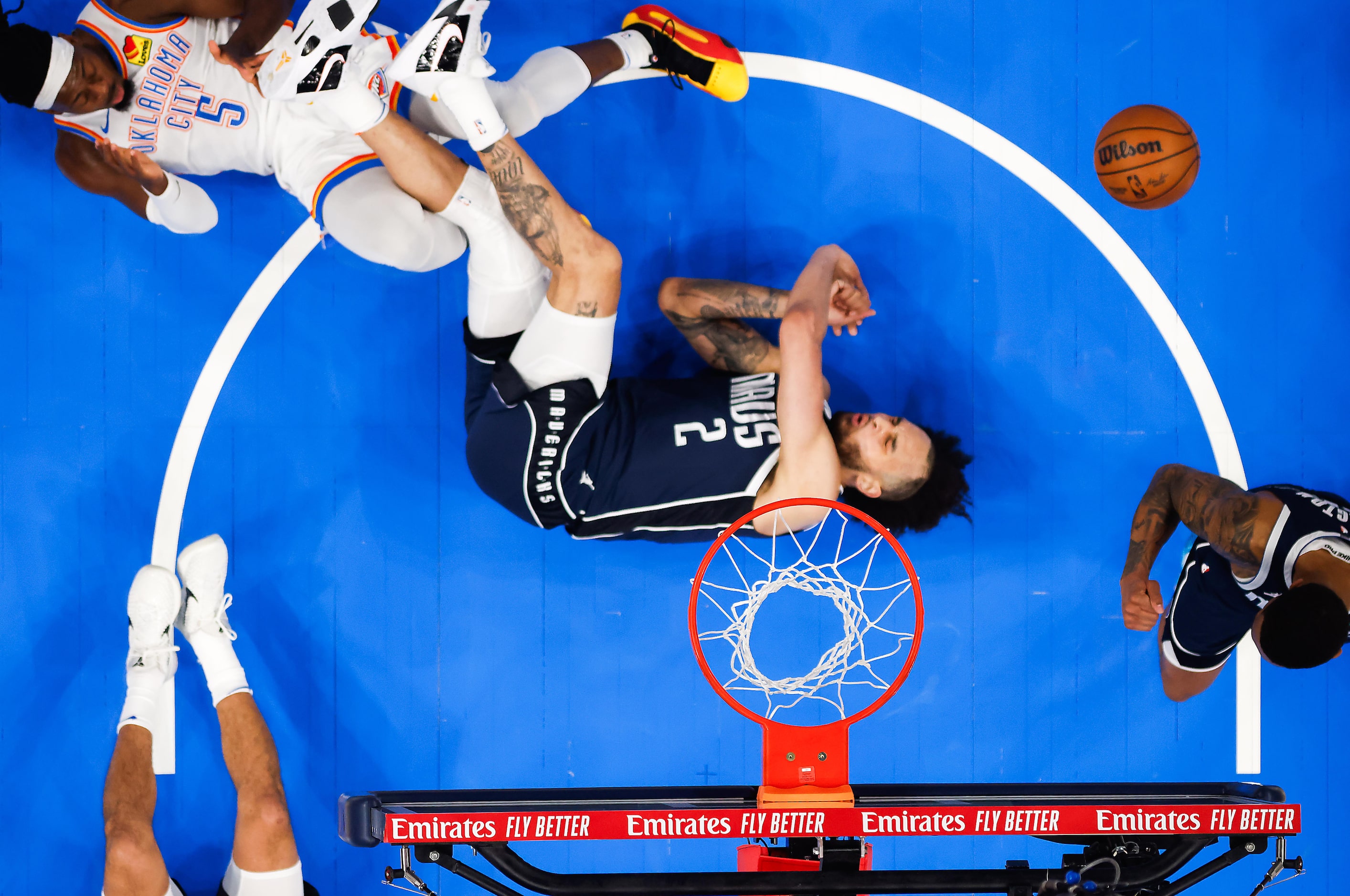 Dallas Mavericks center Dereck Lively II (2) tumbles to the floor after a collision with...