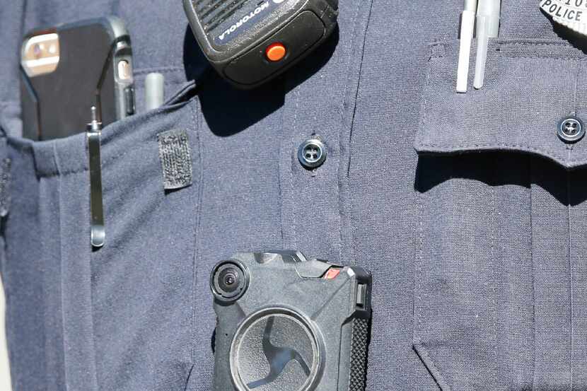 An Axon body camera can be seen on a Dallas police officer at the scene of an active shooter...