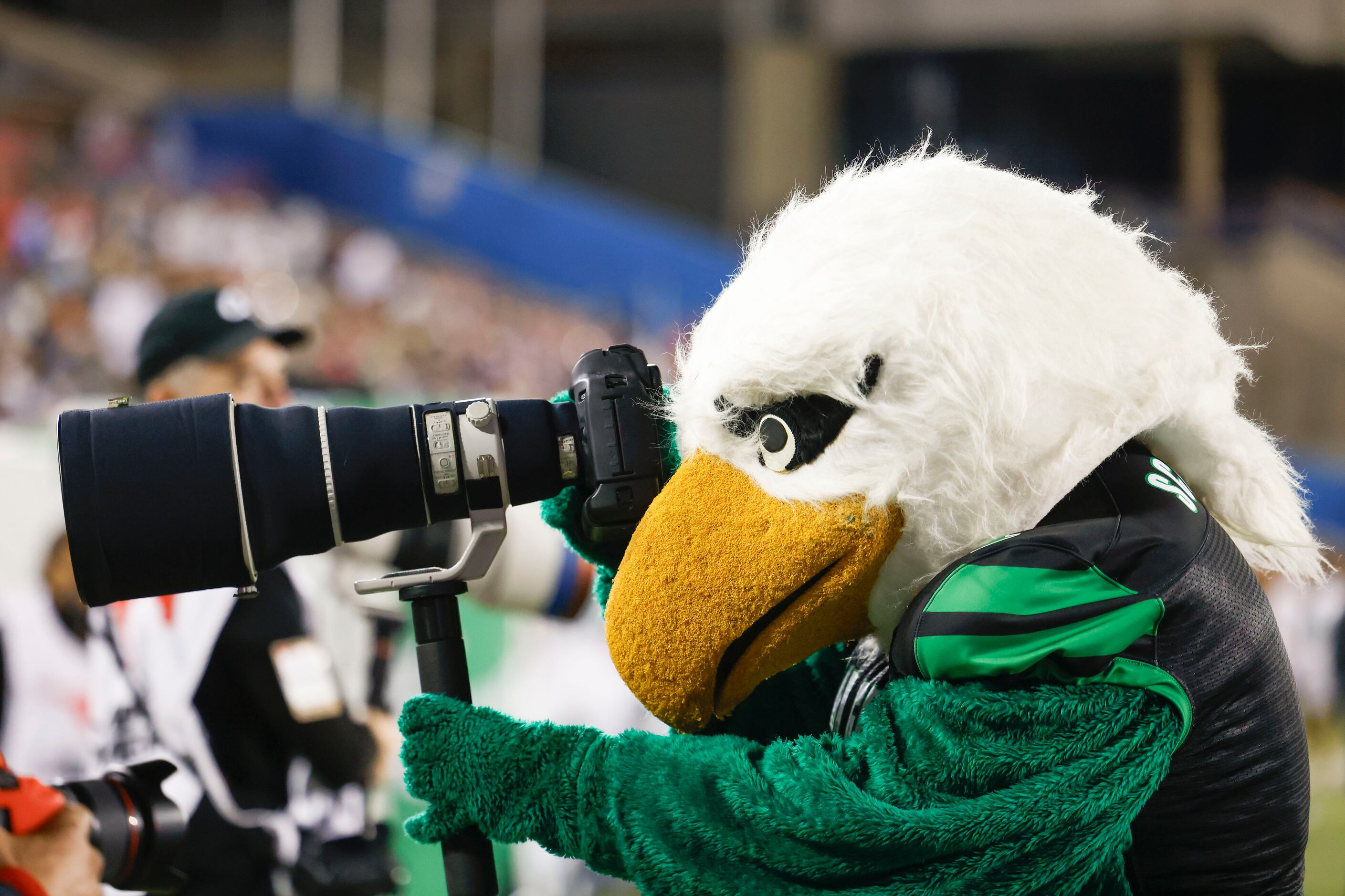 UNT’s mascot Scrappy the Eagle takes a photo with a photographer’s camera during the first...