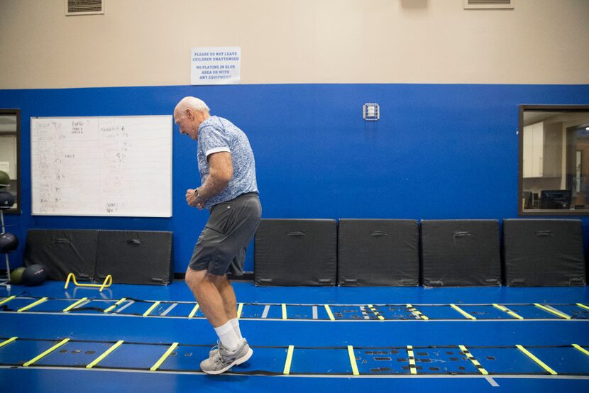 Sam Shields, 79, assistant football coach of the Trinity Christian Trojans works out at the...