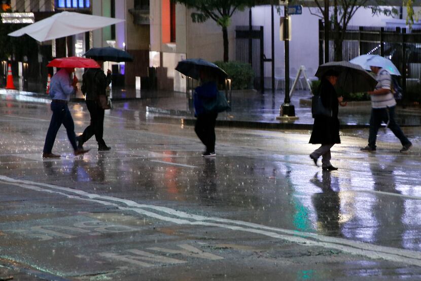 People make their way through wet and cold conditions as temperatures dropped into the 40's...