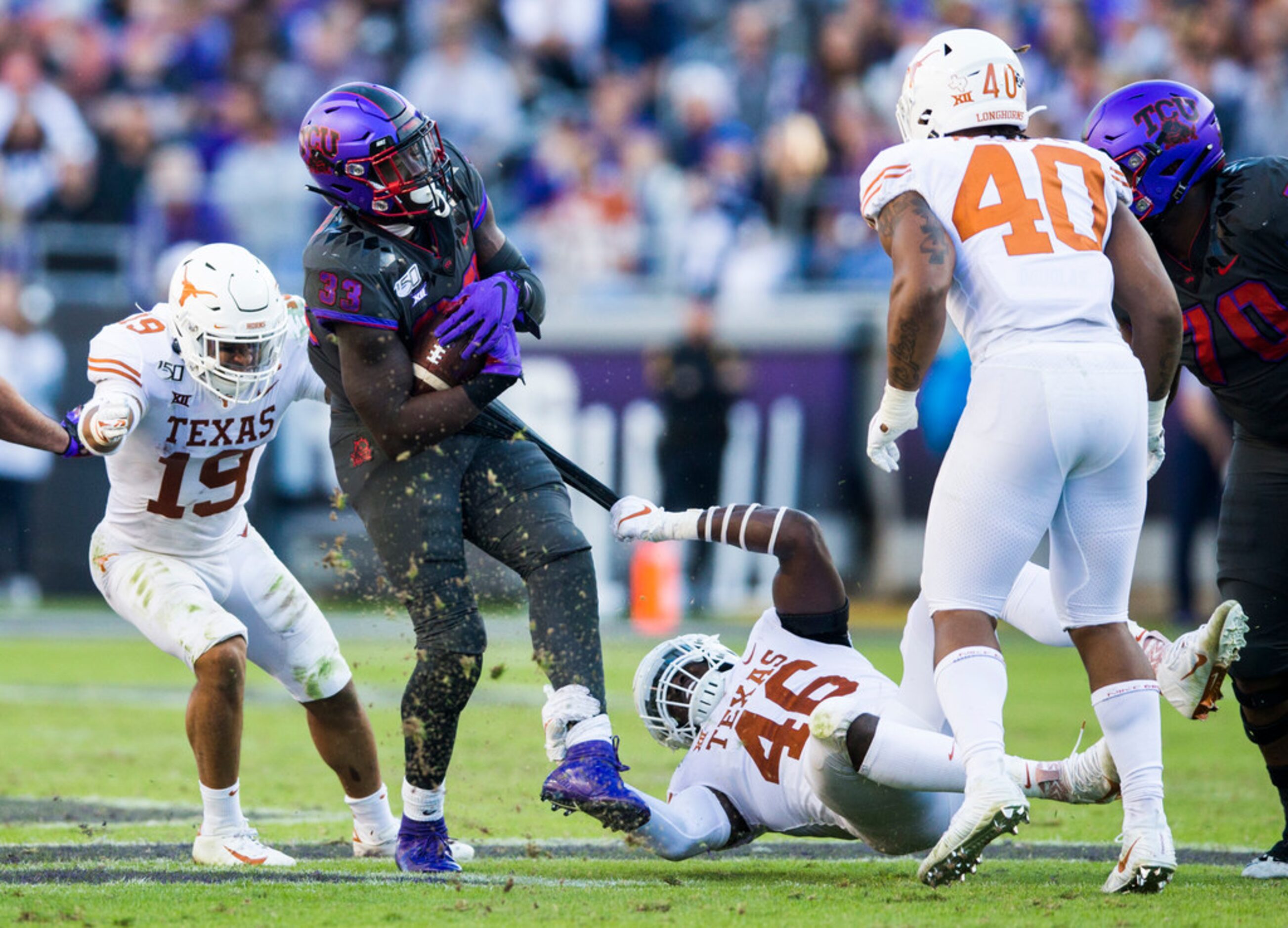 TCU Horned Frogs running back Sewo Olonilua (33) is taken down by Texas Longhorns linebacker...