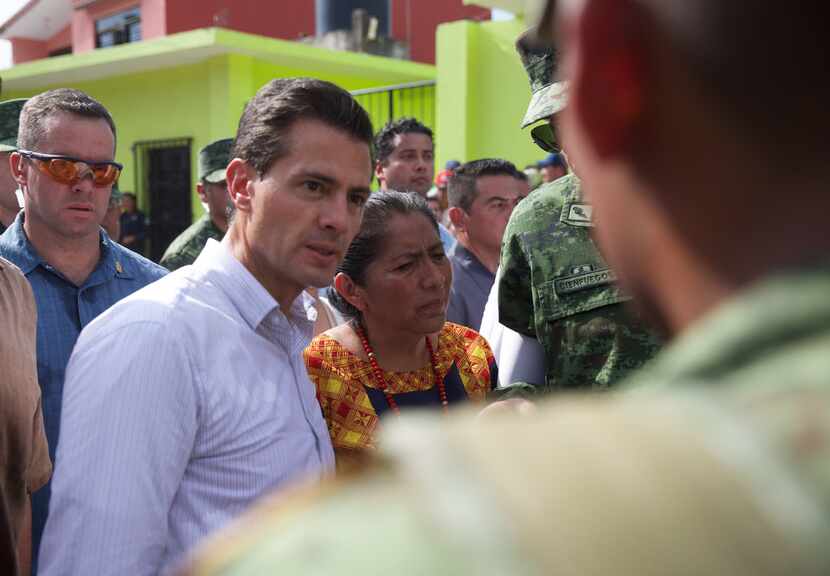 Mexican President Enrique Pena Nieto visits a zone affected by an earthquake in Oaxaca,...