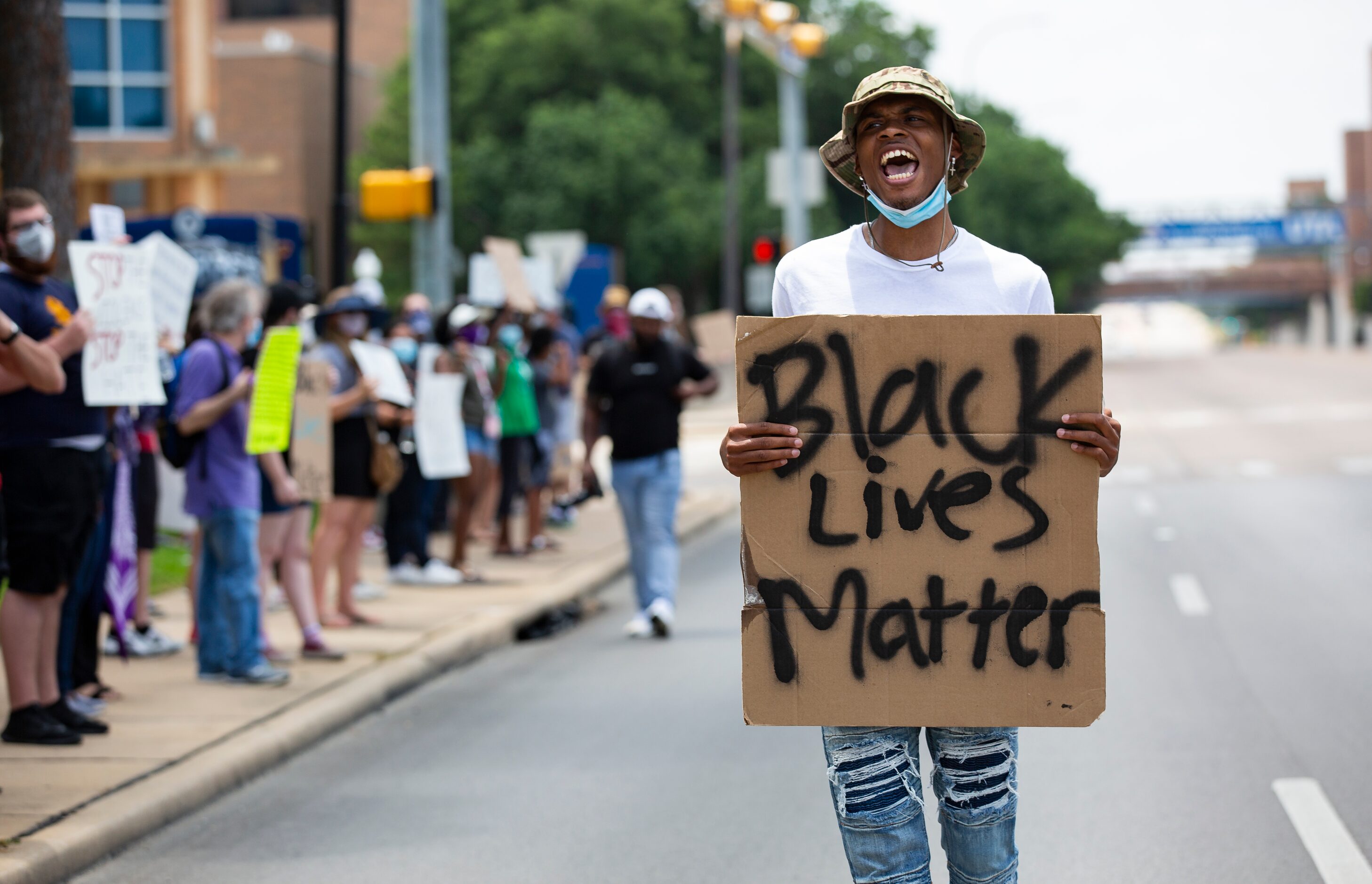 Zyshonne Harris, a senior at UT Arlington, leads the chant as protesters against police...